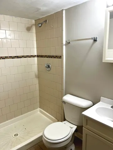 a white toilet and tub sitting next to a bathroom sink