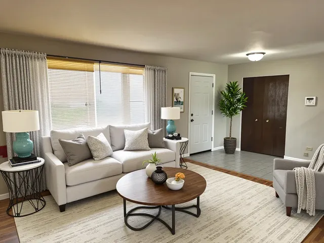 a living room with furniture and a large window