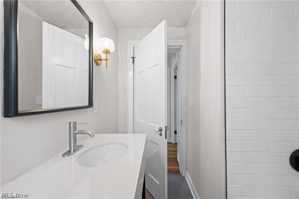 3145 Huntington Road Shaker Heights, OH 44120 - Photo 23 of 28 Bathroom vanity featuring a white countertop, undermount sink, and brushed nickel faucet