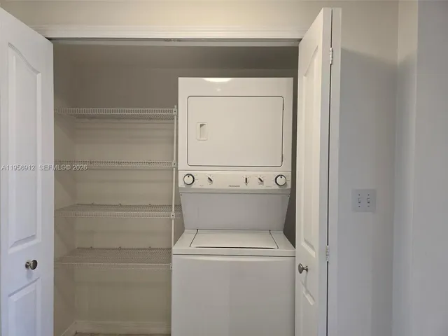a view of a kitchen with a sink and a refrigerator
