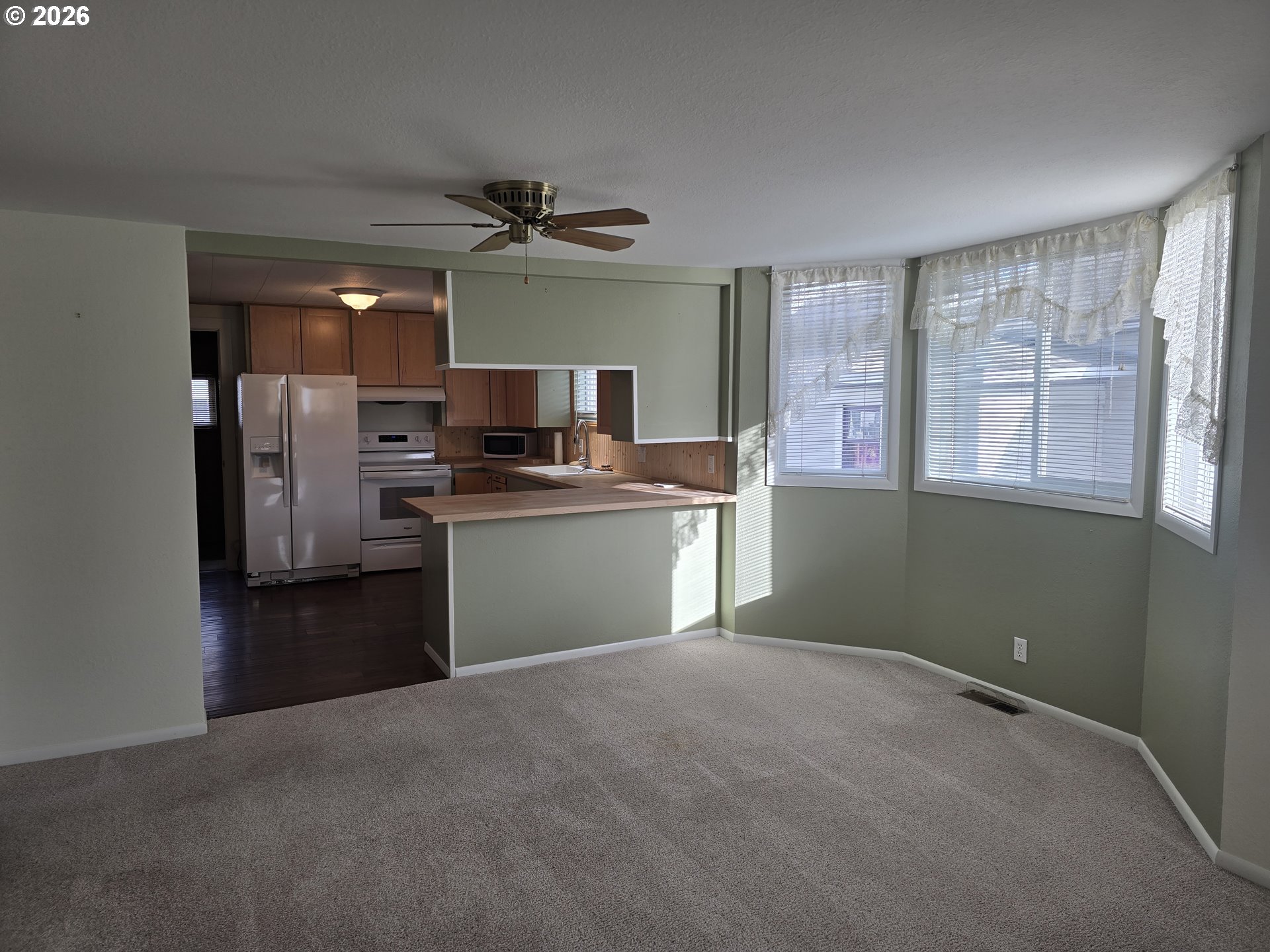 403 Southwest Depot Street Enterprise, OR 97828 - Photo 11 of 27 a kitchen with stainless steel appliances kitchen island a refrigerator sink and stove
