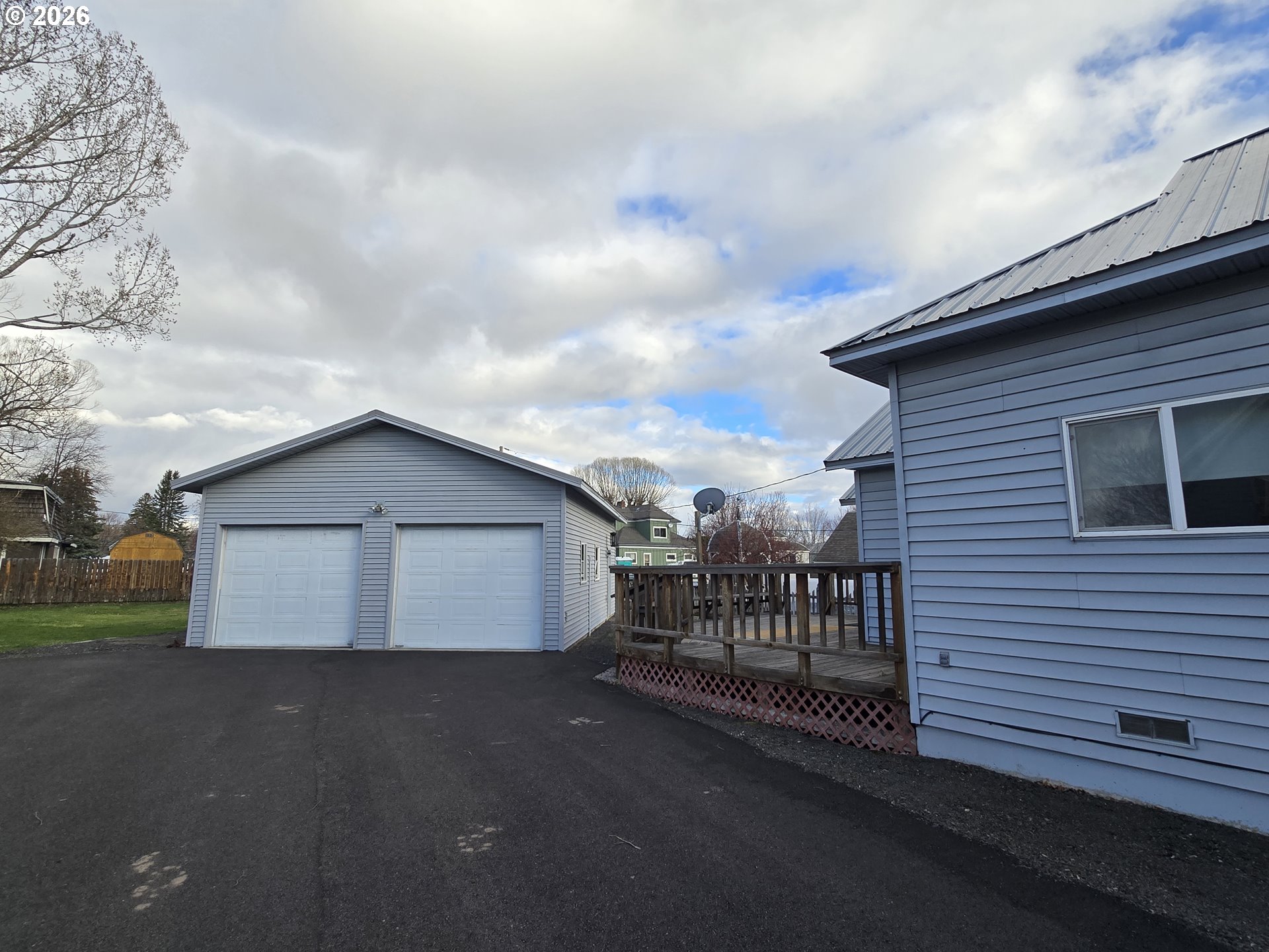 403 Southwest Depot Street Enterprise, OR 97828 - Photo 3 of 27 a view of a house with a yard and wooden fence
