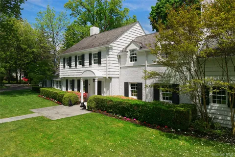 a front view of a house with a yard table and chairs