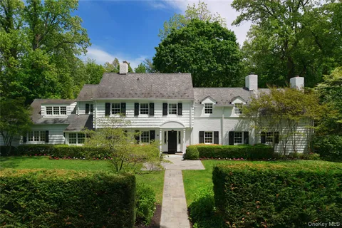 a front view of a residential apartment building with a yard