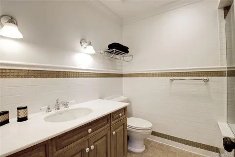 a spacious bedroom with a bed and a dresser