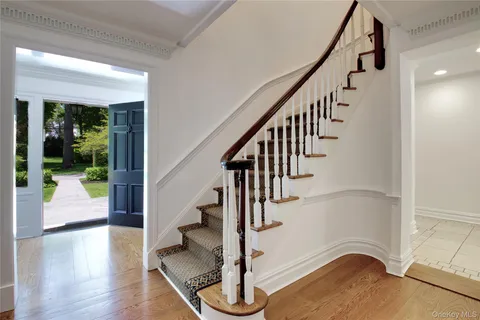 a view of entryway and hall with wooden floor