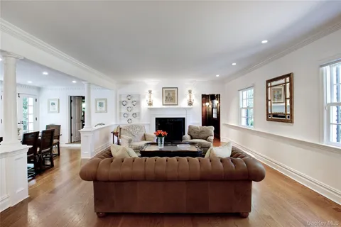 a living room with furniture a fireplace and a window