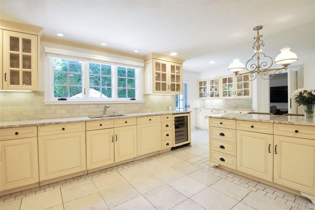 a kitchen with cabinets appliances and a window