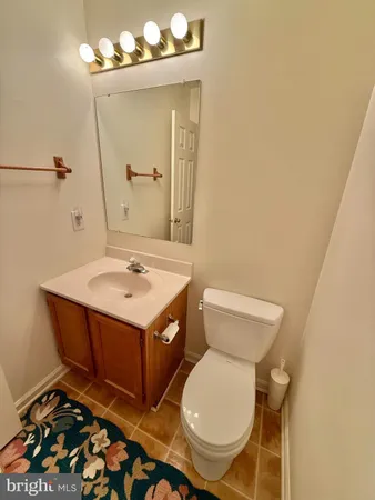 a bathroom with a sink mirror vanity and toilet