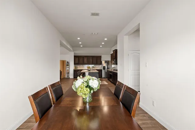 a view of a dining room with furniture and a potted plant