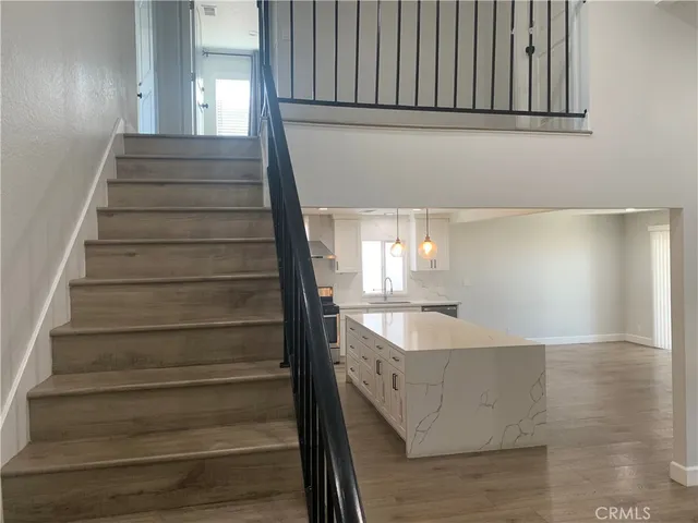 a view of entryway and hall with wooden floor
