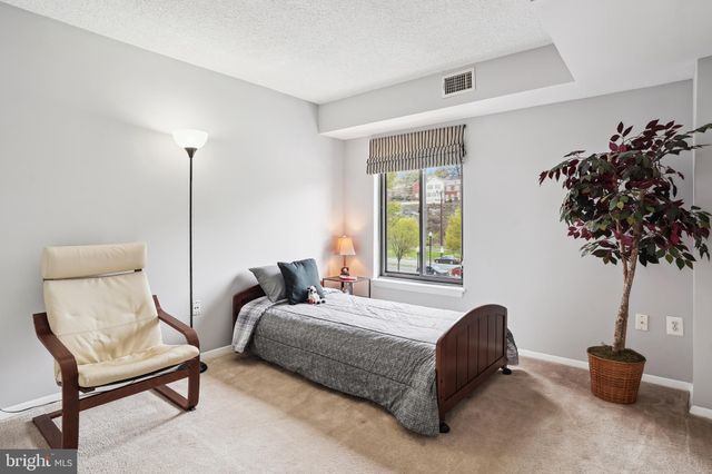 a bedroom with a bed and a potted plant