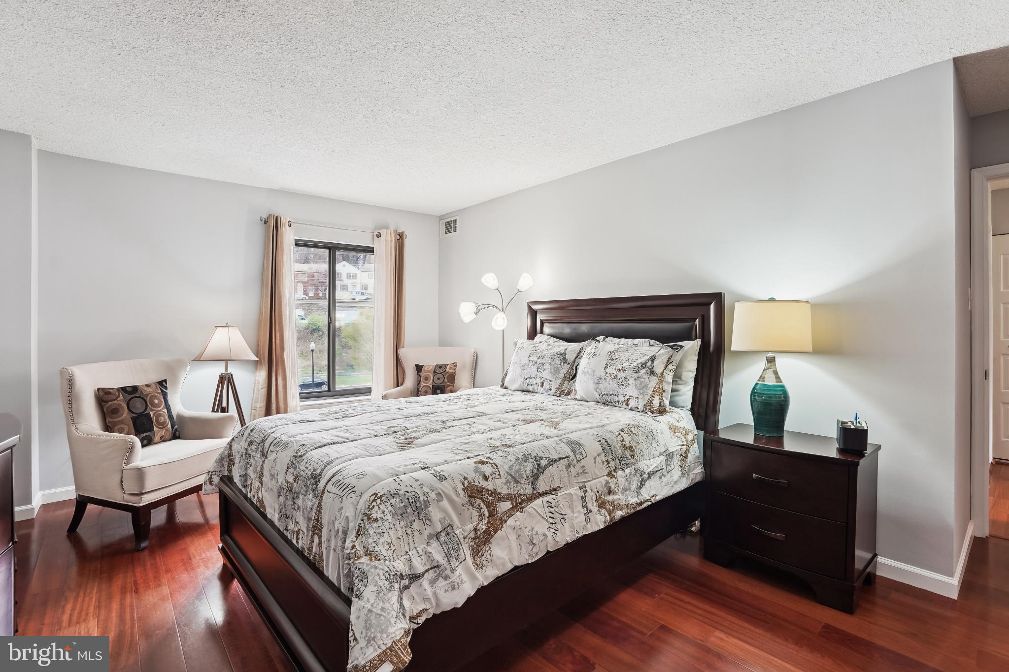 4500 South Four Mile Run Drive, Unit 129 Arlington, VA 22204 - Photo 13 of 34 a bedroom with a bed and wooden floor