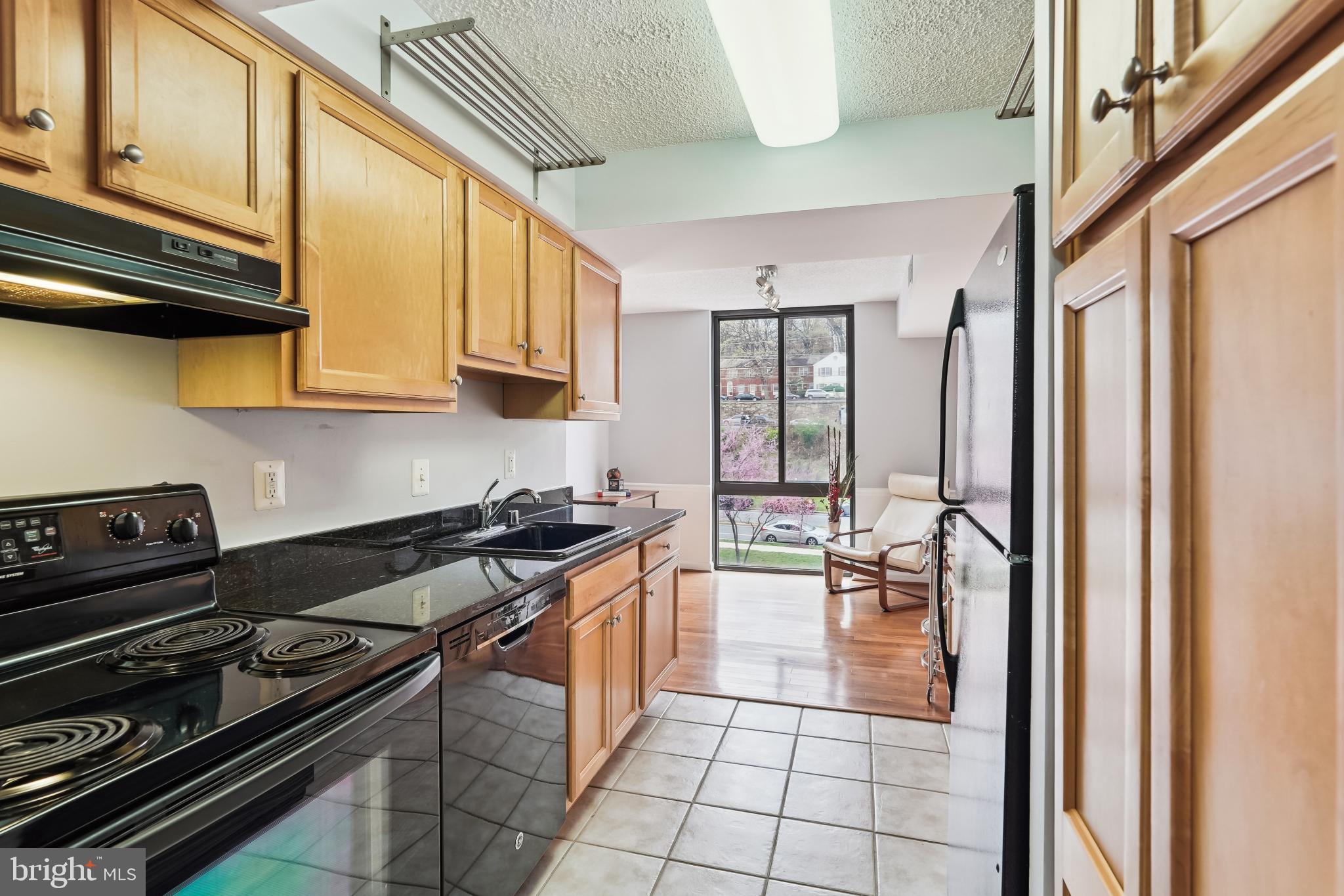 4500 South Four Mile Run Drive, Unit 129 Arlington, VA 22204 - Photo 3 of 34 a kitchen with a stove a sink and cabinets