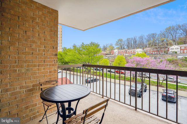 a view of a balcony with furniture and a floor to ceiling window