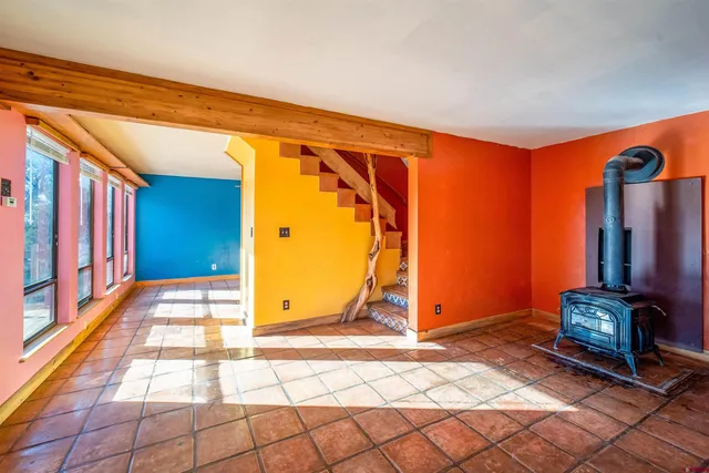 a living room with a bed and a window