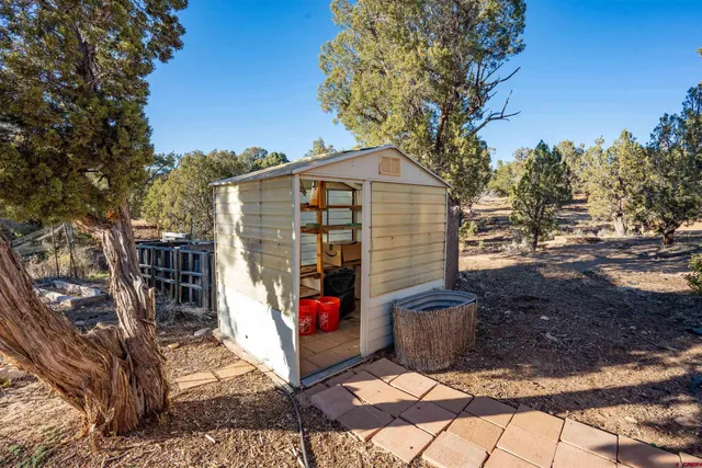 an aerial view of a house with a yard swimming pool and outdoor seating