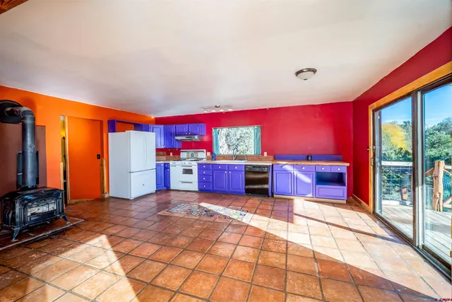 a kitchen with stainless steel appliances a stove top oven a sink dishwasher and wooden cabinets