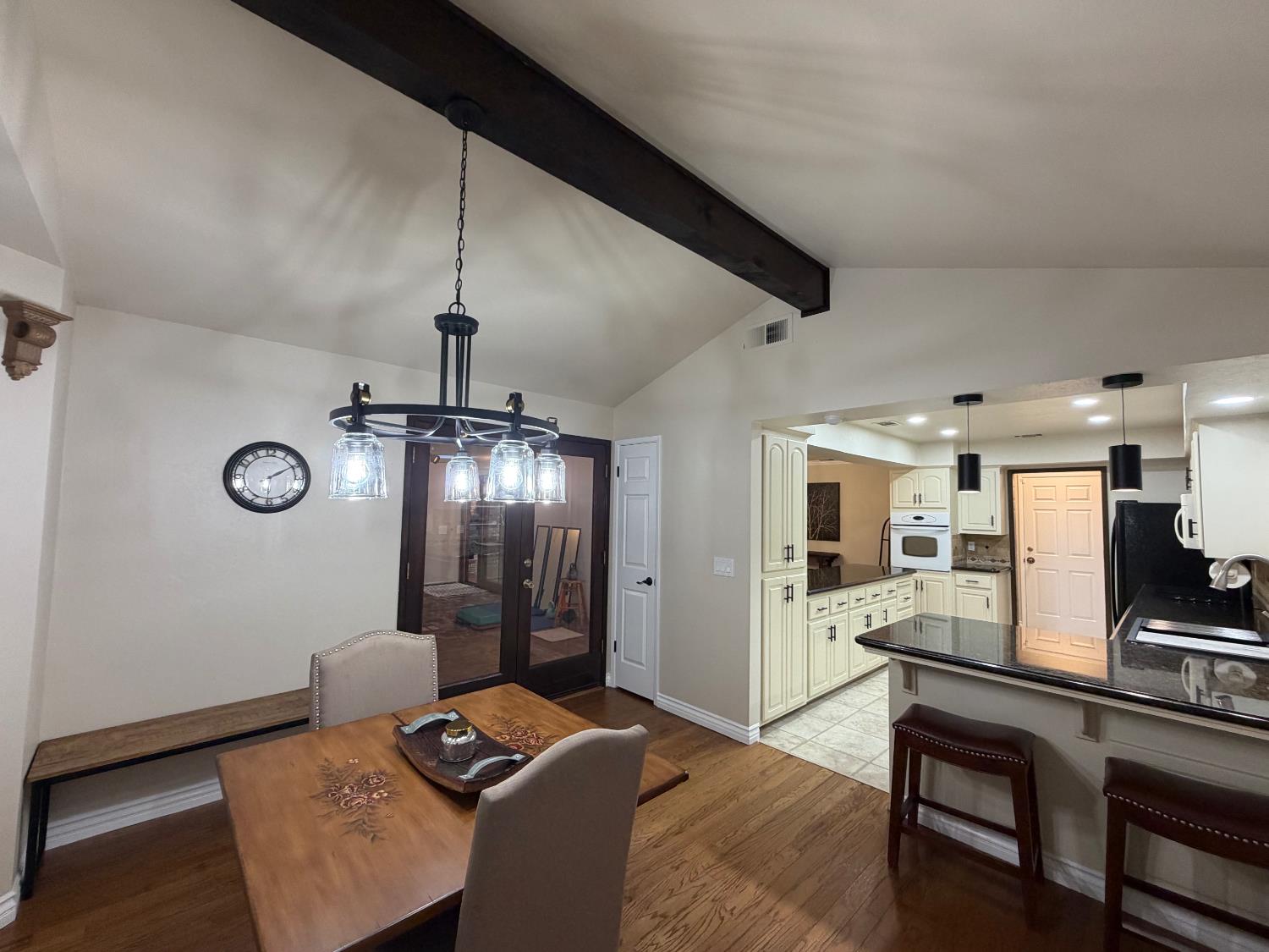 5706 Jeff Way Carmichael, CA 95608 - Photo 17 of 48 Kitchen eating area has beautiful open beam ceiling, bay window and kitchen eating bar with new pendant lights.