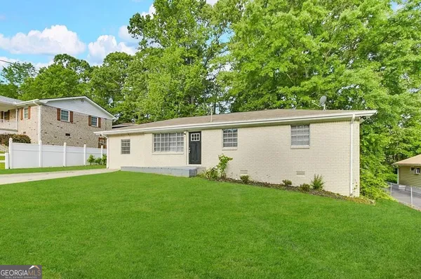 a front view of house with yard and green space