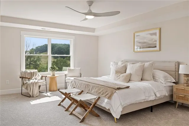 a bedroom with a bed and a large window