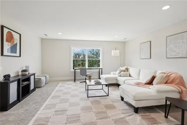 a living room with furniture rug and window