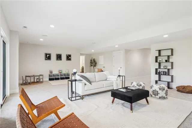 a living room with furniture a rug and a wall painting