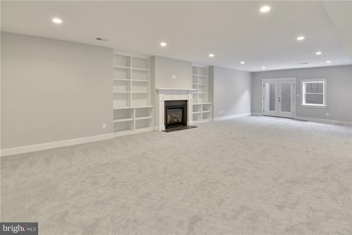 607 Kingsley Road Southwest Vienna, VA 22180 - Photo 26 of 30 Recreation Room with Fireplace and French Doors