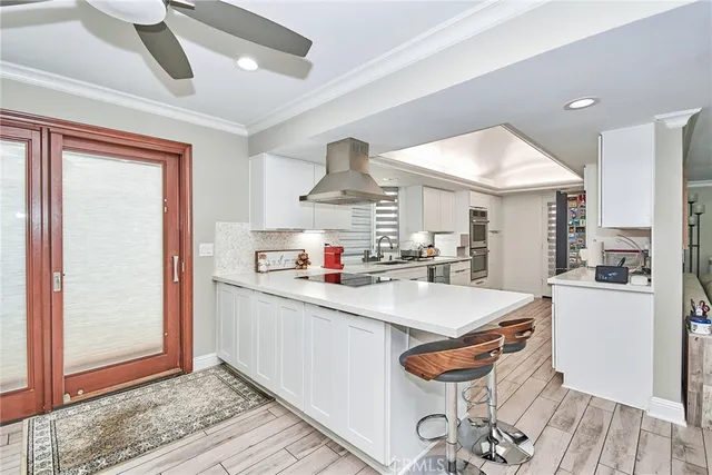 a kitchen with stainless steel appliances granite countertop a sink and a refrigerator
