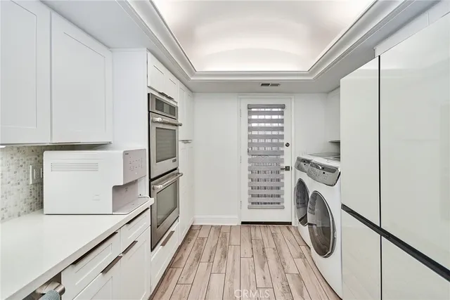a kitchen with a refrigerator and a stove