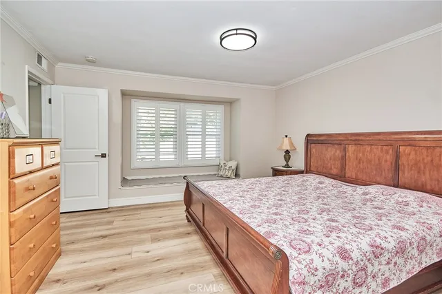 a spacious bedroom with a large bed and a dresser