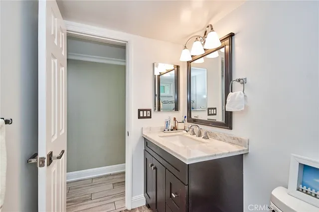 a bathroom with a sink vanity and a mirror
