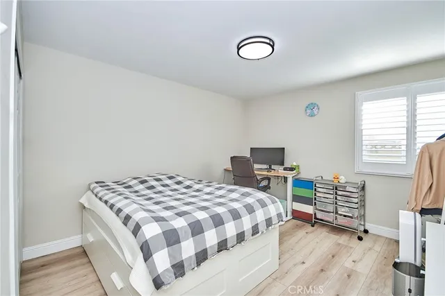 a bedroom with a bed and a chair in it