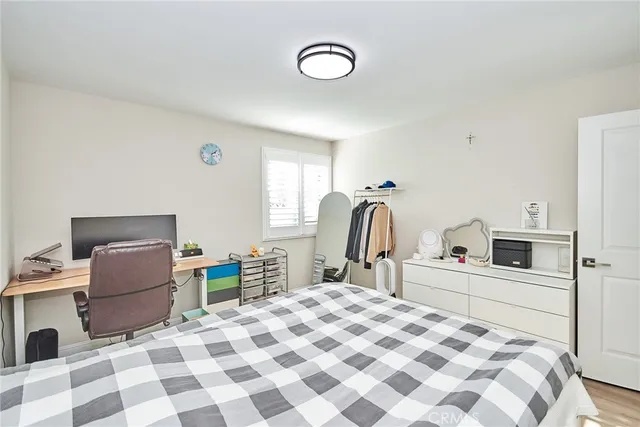 a bedroom with a bed and a television