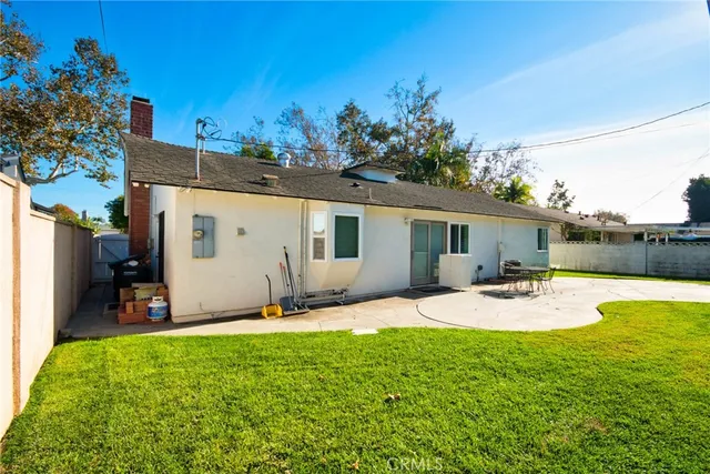 a view of a backyard with table and chairs and a yard