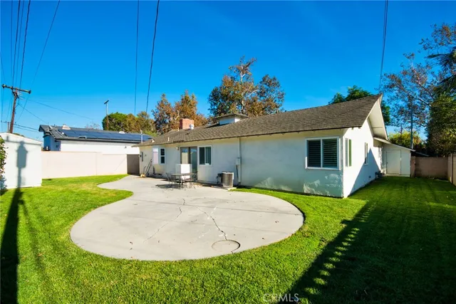 a view of a house with a backyard