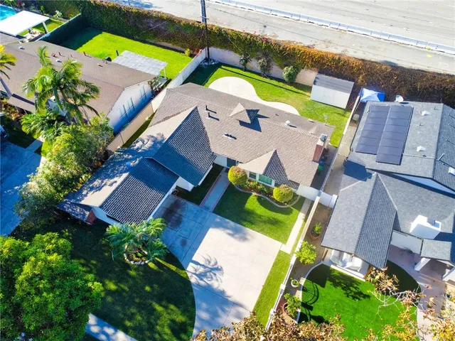 an aerial view of a house with a yard and a garden