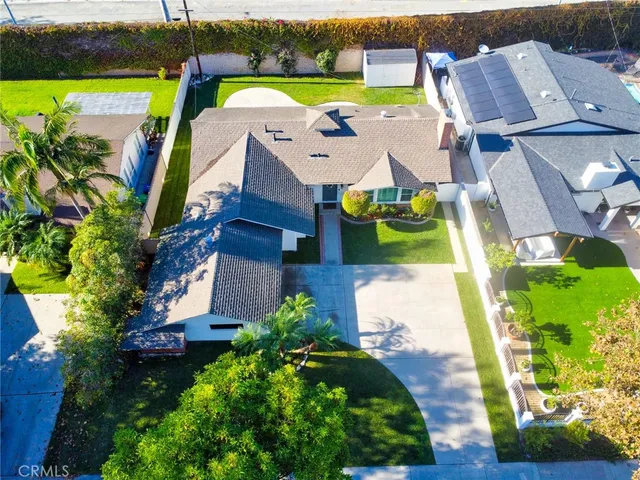 an aerial view of a house with a yard basket ball court and outdoor seating