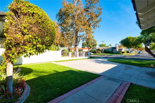 a view of yard with swimming pool and green space
