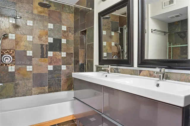 a bathroom with a bathtub and a sink