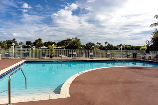 a view of a swimming pool with an outdoor seating