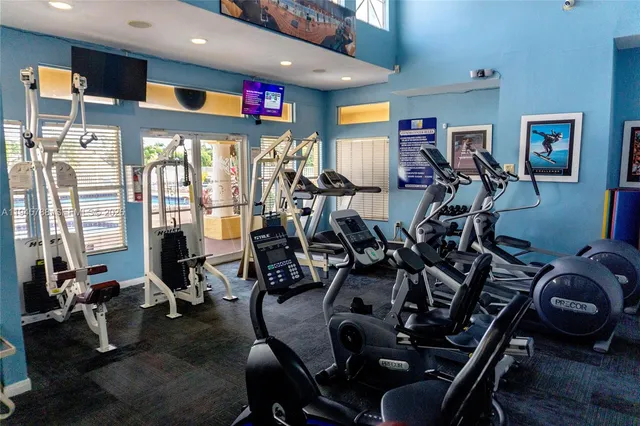 a room with gym equipment and windows