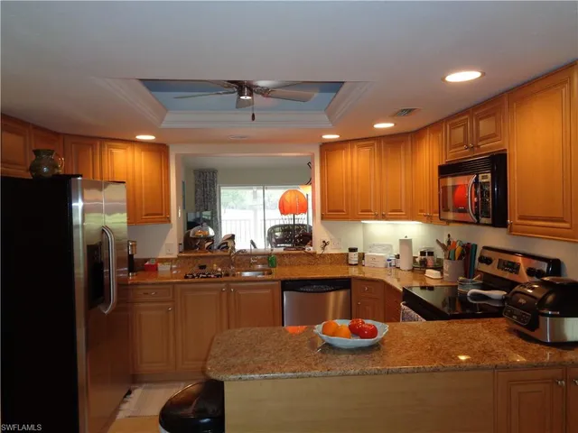 a kitchen with a sink appliances and cabinets
