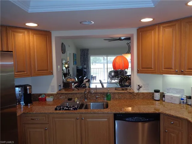 a kitchen with stainless steel appliances granite countertop a sink a stove and a cabinets