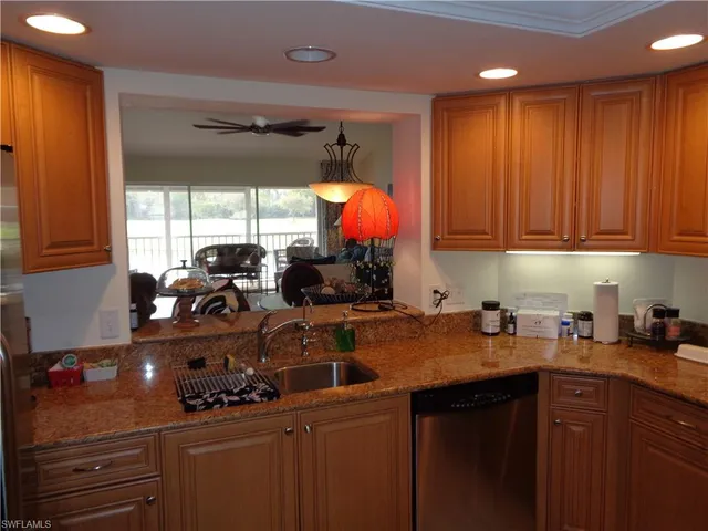 a kitchen with a sink cabinets and window
