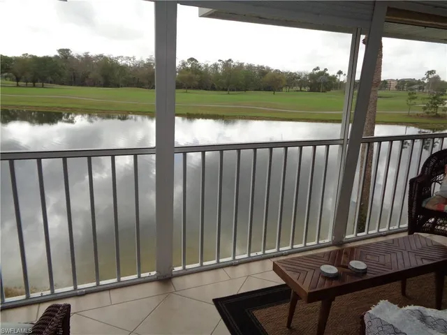 a view of a two chairs in the deck next to a yard