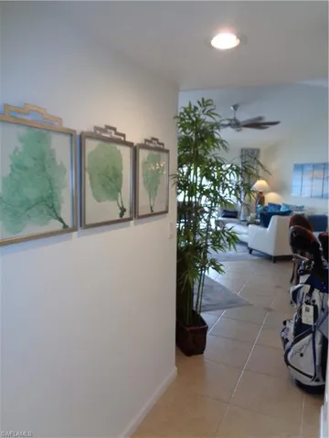 a hallway with a flower pot and a dining table