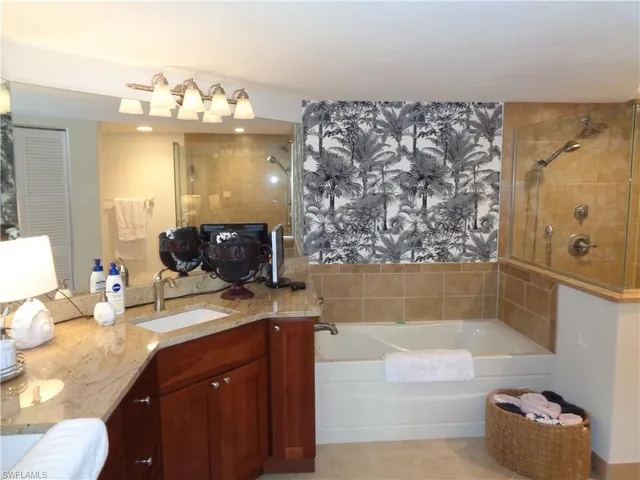 a bathroom with a bathtub sink and mirror