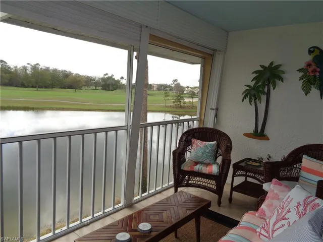 a view of a chairs and table in the balcony