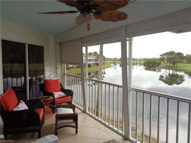 a city view from a balcony with furniture